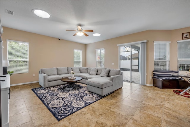 710 Grape Ivy Ln, New Smyrna Beach, FL 32168 - tiled living area with a ceiling fan and plenty of natural light