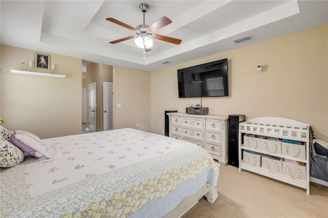 710 Grape Ivy Ln, New Smyrna Beach, FL 32168 - bedroom featuring a raised ceiling, light carpet, and a ceiling fan