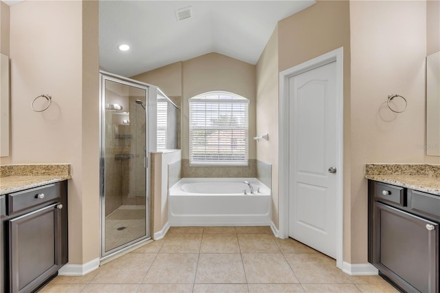 710 Grape Ivy Ln, New Smyrna Beach, FL 32168 - full bath featuring vanity, lofted ceiling, a shower stall, a garden tub, and tile patterned flooring