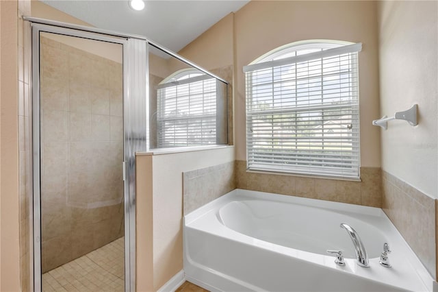 710 Grape Ivy Ln, New Smyrna Beach, FL 32168 - bathroom with healthy amount of natural light, a garden tub, and a stall shower
