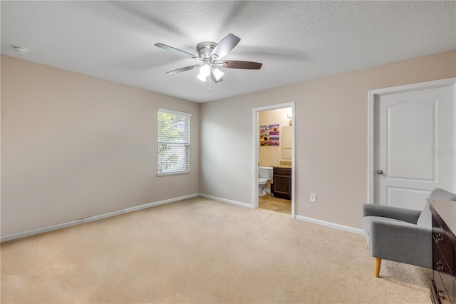 710 Grape Ivy Ln, New Smyrna Beach, FL 32168 - bedroom with light colored carpet, a textured ceiling, ensuite bathroom, and ceiling fan