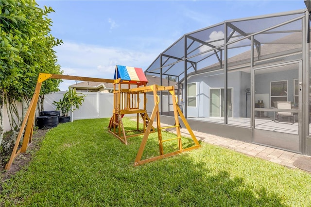 710 Grape Ivy Ln, New Smyrna Beach, FL 32168 - fenced backyard with a playground, glass enclosure, and a patio