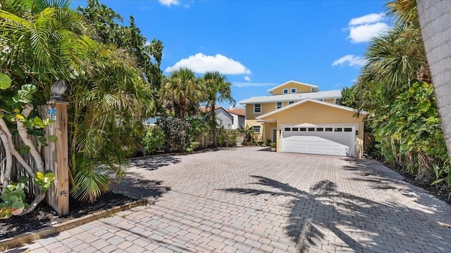 943 S Atlantic Ave, Cocoa Beach, FL 32931 - view of front of house featuring an attached garage and decorative driveway