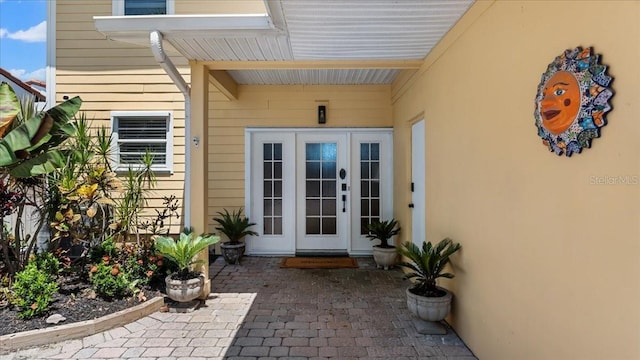 943 S Atlantic Ave, Cocoa Beach, FL 32931 - doorway to property with french doors and stucco siding
