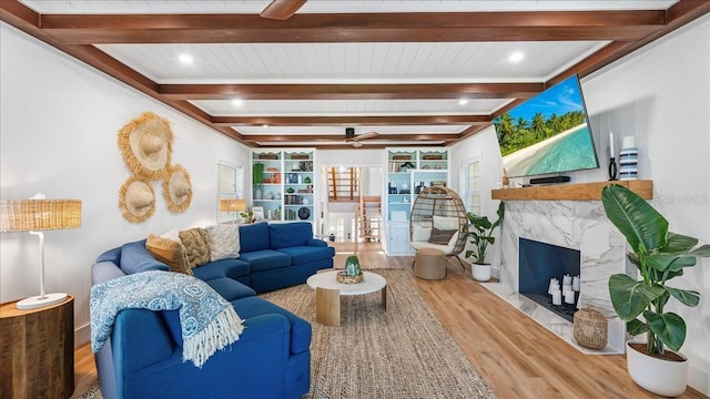 943 S Atlantic Ave, Cocoa Beach, FL 32931 - living area featuring a ceiling fan, wood finished floors, beam ceiling, a fireplace, and ornamental molding