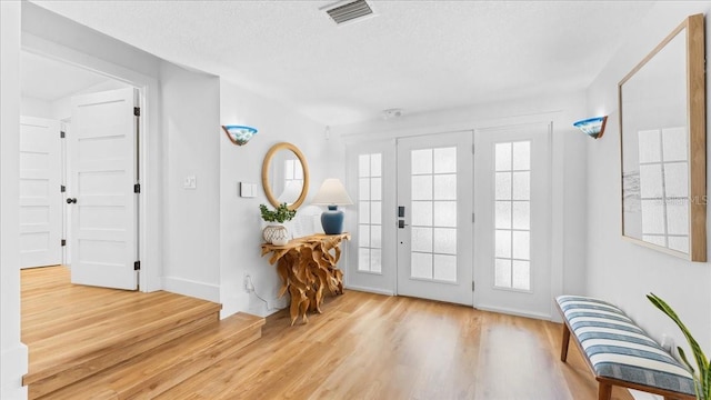 943 S Atlantic Ave, Cocoa Beach, FL 32931 - foyer entrance featuring wood finished floors and a textured ceiling