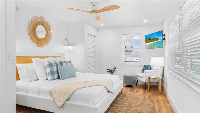 943 S Atlantic Ave, Cocoa Beach, FL 32931 - bedroom with wood finished floors, multiple windows, recessed lighting, and a ceiling fan