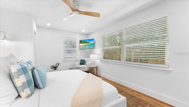 943 S Atlantic Ave, Cocoa Beach, FL 32931 - bedroom with wood finished floors, ceiling fan, and recessed lighting