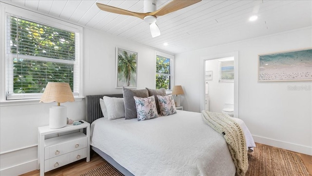 943 S Atlantic Ave, Cocoa Beach, FL 32931 - bedroom featuring wood finished floors, wooden ceiling, ensuite bathroom, and ceiling fan