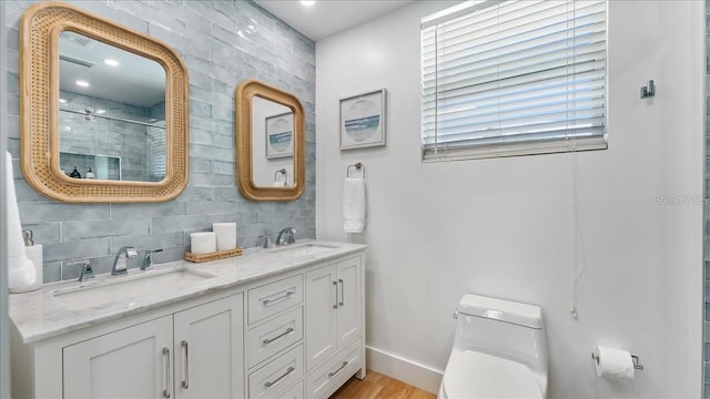 943 S Atlantic Ave, Cocoa Beach, FL 32931 - full bathroom featuring a shower stall, double vanity, wood finished floors, and backsplash