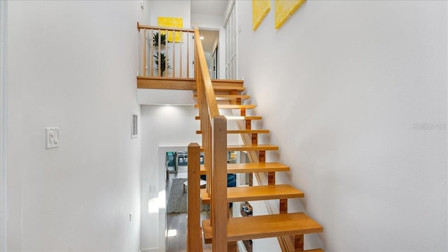 943 S Atlantic Ave, Cocoa Beach, FL 32931 - stairs featuring a towering ceiling