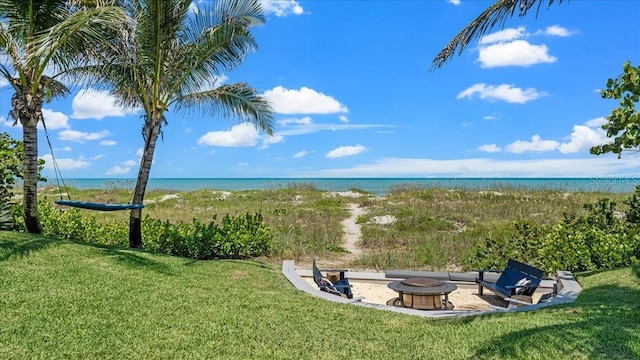 943 S Atlantic Ave, Cocoa Beach, FL 32931 - view of grassy yard with a fire pit and a water view