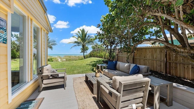 943 S Atlantic Ave, Cocoa Beach, FL 32931 - view of patio with an outdoor living space and a water view