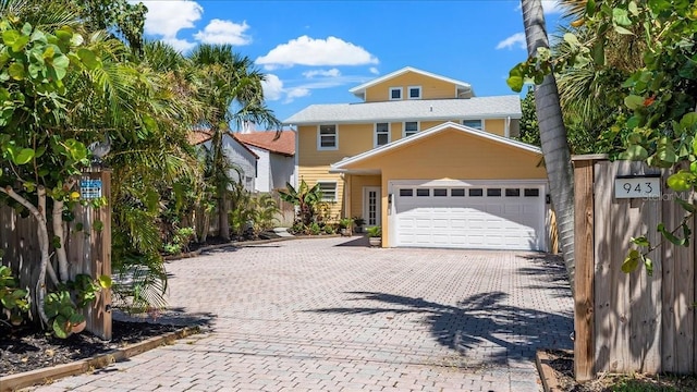 943 S Atlantic Ave, Cocoa Beach, FL 32931 - view of front of property with an attached garage and decorative driveway