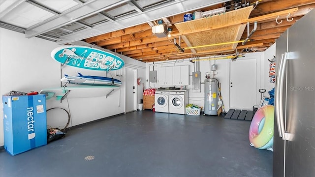 943 S Atlantic Ave, Cocoa Beach, FL 32931 - garage featuring washer and clothes dryer, electric water heater, freestanding refrigerator, a garage door opener, and electric panel