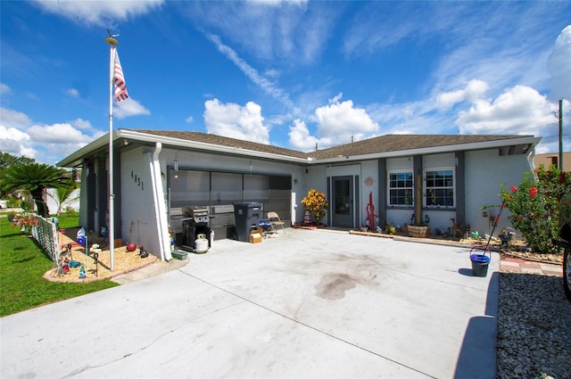 4831 Cypress Tree Dr, Tampa, FL 33624 - view of front of house featuring stucco siding, an attached garage, and driveway