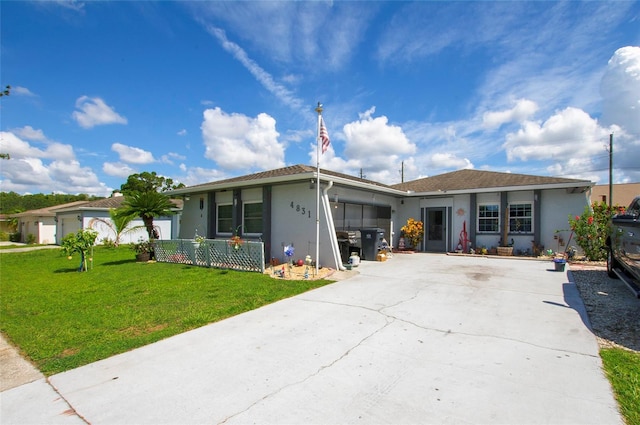 4831 Cypress Tree Dr, Tampa, FL 33624 - ranch-style house with stucco siding, driveway, a front yard, and an attached garage