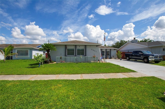 4831 Cypress Tree Dr, Tampa, FL 33624 - single story home with a front yard, stucco siding, and driveway