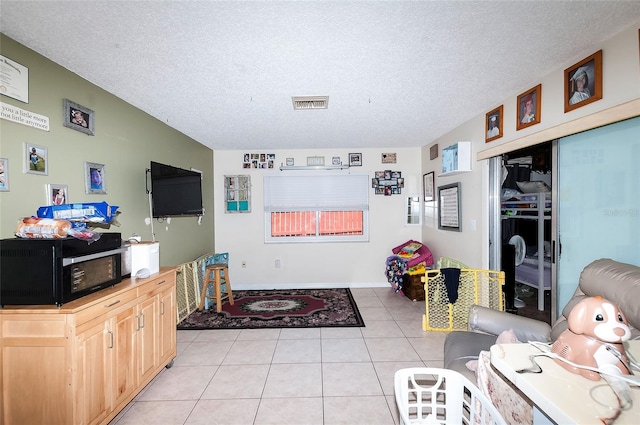 4831 Cypress Tree Dr, Tampa, FL 33624 - living area featuring a textured ceiling and light tile patterned flooring
