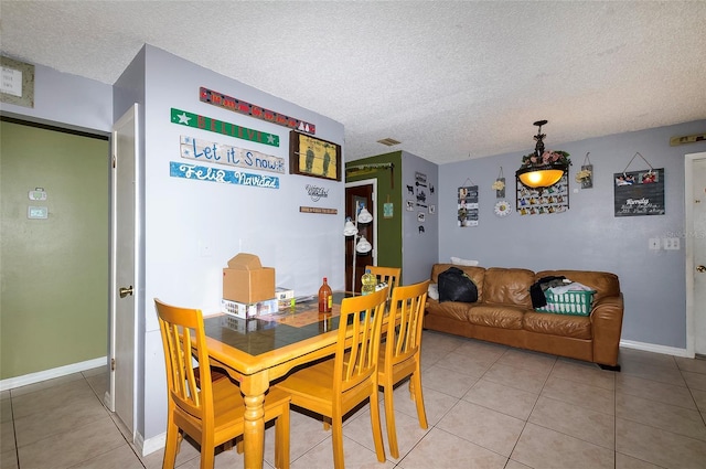 4831 Cypress Tree Dr, Tampa, FL 33624 - dining room featuring a textured ceiling and light tile patterned floors