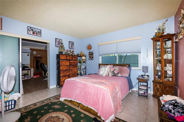 4831 Cypress Tree Dr, Tampa, FL 33624 - bedroom with tile patterned flooring and a textured ceiling