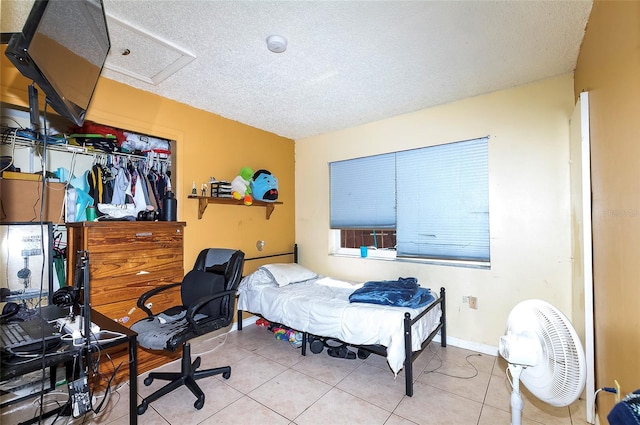 4831 Cypress Tree Dr, Tampa, FL 33624 - tiled bedroom with a textured ceiling, attic access, and a closet