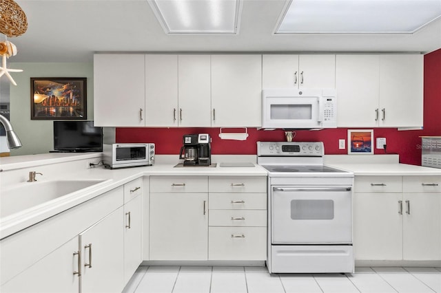 4 Oceans W Blvd Unit 308C, Daytona Beach, FL 32118 - kitchen with white appliances, light countertops, white cabinetry, and light tile patterned floors