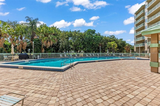 4 Oceans W Blvd Unit 308C, Daytona Beach, FL 32118 - community pool featuring a patio and view of wooded area