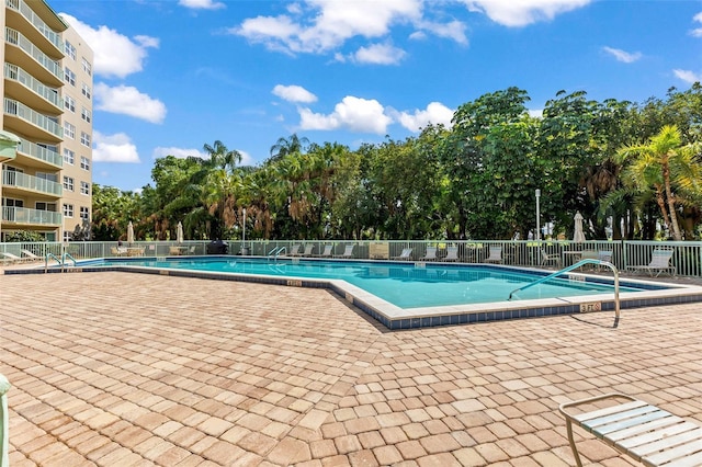 4 Oceans W Blvd Unit 308C, Daytona Beach, FL 32118 - community pool featuring a patio and view of scattered trees