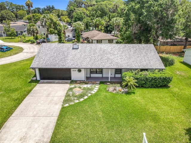 1019 Chippewa Trl, Daytona Beach, FL 32117 - view of front facade featuring roof with shingles, concrete driveway, a porch, a garage, and a residential view