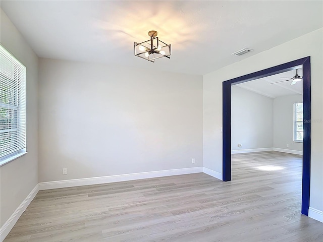 1019 Chippewa Trl, Daytona Beach, FL 32117 - empty room featuring a chandelier, light wood-style flooring, and a ceiling fan