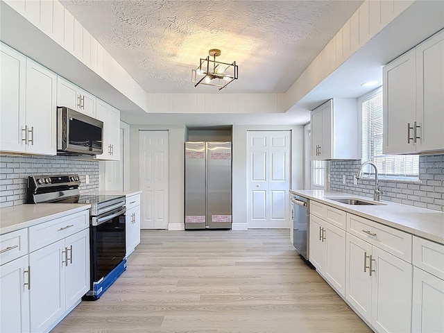 1019 Chippewa Trl, Daytona Beach, FL 32117 - kitchen featuring appliances with stainless steel finishes, a textured ceiling, light countertops, and backsplash