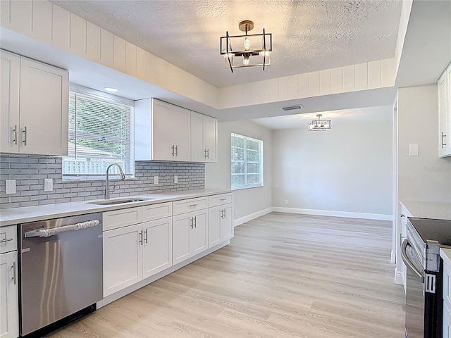 1019 Chippewa Trl, Daytona Beach, FL 32117 - kitchen featuring dishwasher, range with electric cooktop, light countertops, decorative backsplash, and light wood-style floors