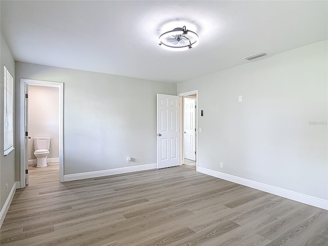 1019 Chippewa Trl, Daytona Beach, FL 32117 - unfurnished bedroom featuring light wood-type flooring and ensuite bath