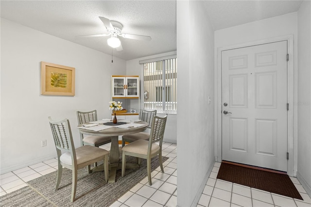3 Oceans W Blvd Unit 3A7, Daytona Beach Shores, FL 32118 - dining area featuring ceiling fan, light tile patterned floors, and a textured ceiling