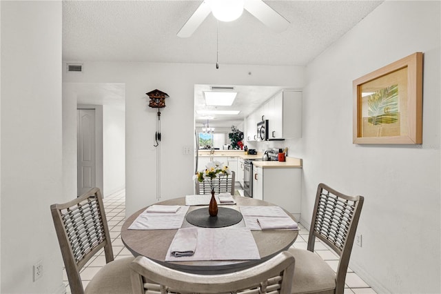 3 Oceans W Blvd Unit 3A7, Daytona Beach Shores, FL 32118 - dining space with light tile patterned flooring, a textured ceiling, and a ceiling fan