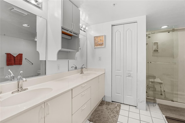 3 Oceans W Blvd Unit 3A7, Daytona Beach Shores, FL 32118 - bathroom featuring double vanity, tile patterned floors, a stall shower, a closet, and recessed lighting