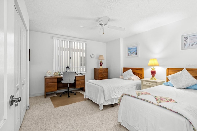 3 Oceans W Blvd Unit 3A7, Daytona Beach Shores, FL 32118 - bedroom featuring a desk, light colored carpet, a textured ceiling, and ceiling fan