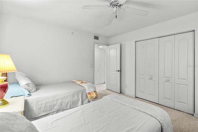3 Oceans W Blvd Unit 3A7, Daytona Beach Shores, FL 32118 - bedroom featuring light colored carpet, a closet, ceiling fan, and a textured ceiling