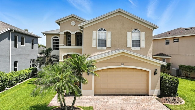 3842 Calliope Ave, Port Orange, FL 32129 - mediterranean / spanish home featuring stucco siding, an attached garage, and decorative driveway