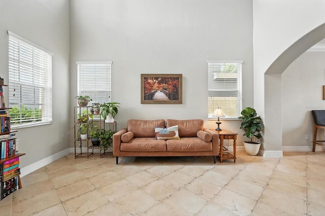 3842 Calliope Ave, Port Orange, FL 32129 - living room featuring arched walkways and a high ceiling