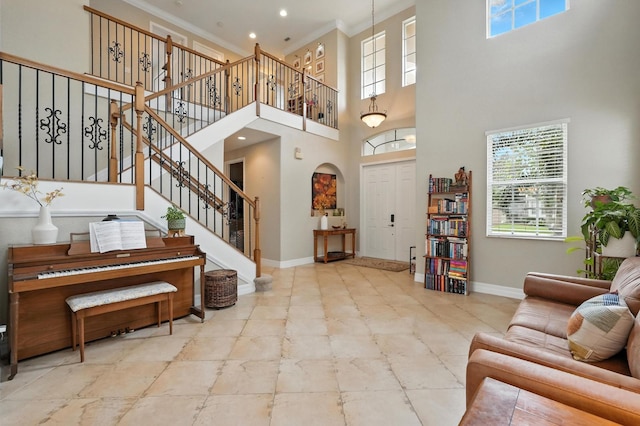 3842 Calliope Ave, Port Orange, FL 32129 - living area featuring a high ceiling, stairway, crown molding, arched walkways, and recessed lighting