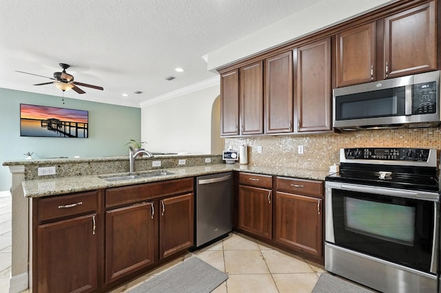 3842 Calliope Ave, Port Orange, FL 32129 - kitchen featuring stainless steel appliances, a peninsula, light stone counters, ornamental molding, and ceiling fan
