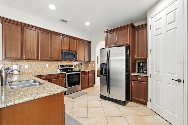 3842 Calliope Ave, Port Orange, FL 32129 - kitchen featuring stainless steel appliances, decorative backsplash, light stone counters, light tile patterned flooring, and recessed lighting