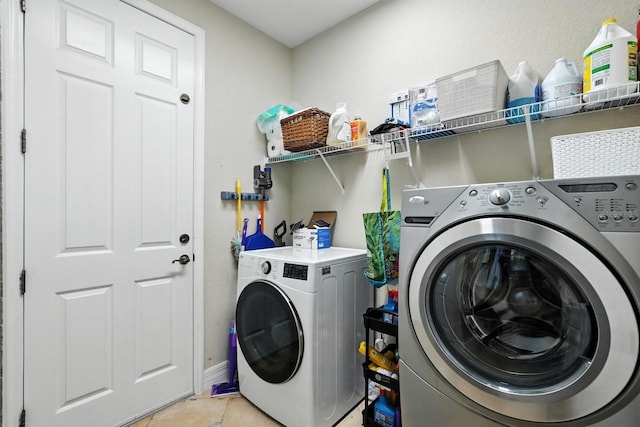 3842 Calliope Ave, Port Orange, FL 32129 - washroom with washer and clothes dryer and light tile patterned floors