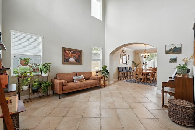 3842 Calliope Ave, Port Orange, FL 32129 - living area featuring a towering ceiling, arched walkways, and a chandelier