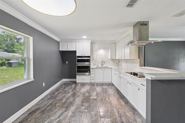 330 Ponce Deleon Blvd, De Leon Springs, FL 32130 - kitchen with wall chimney exhaust hood, ornamental molding, decorative backsplash, stainless steel double oven, and white cabinets