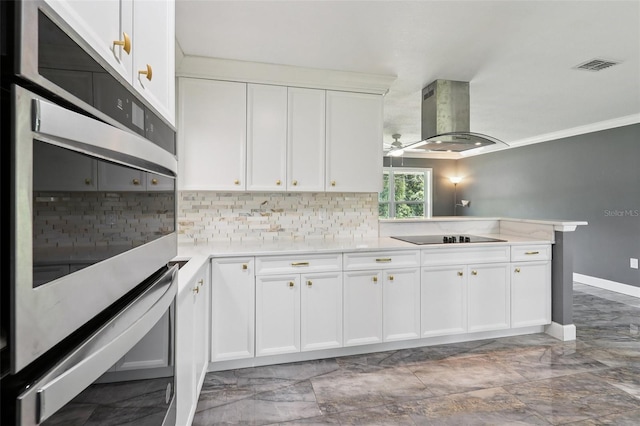 330 Ponce Deleon Blvd, De Leon Springs, FL 32130 - kitchen featuring island range hood, black electric cooktop, decorative backsplash, a ceiling fan, and light countertops