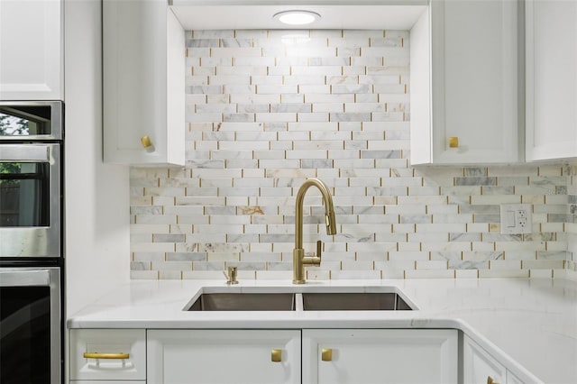 330 Ponce Deleon Blvd, De Leon Springs, FL 32130 - kitchen with double oven, tasteful backsplash, white cabinetry, and light countertops