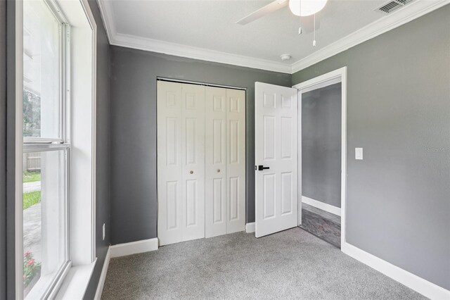 330 Ponce Deleon Blvd, De Leon Springs, FL 32130 - unfurnished bedroom featuring crown molding, carpet floors, a closet, and a ceiling fan
